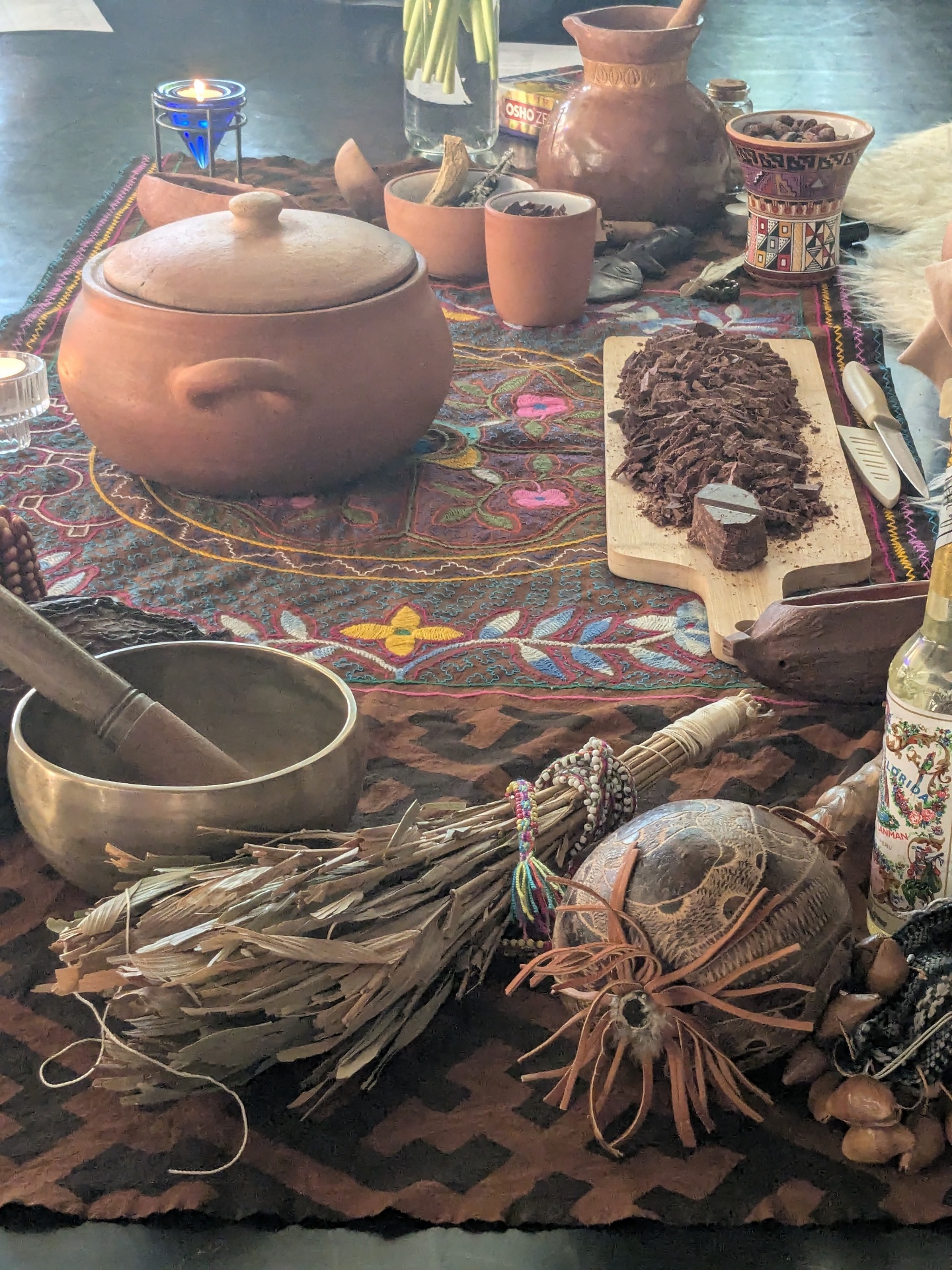 Cacao ceremony altar laid out with clay pots, shredded cacao and sacred objects