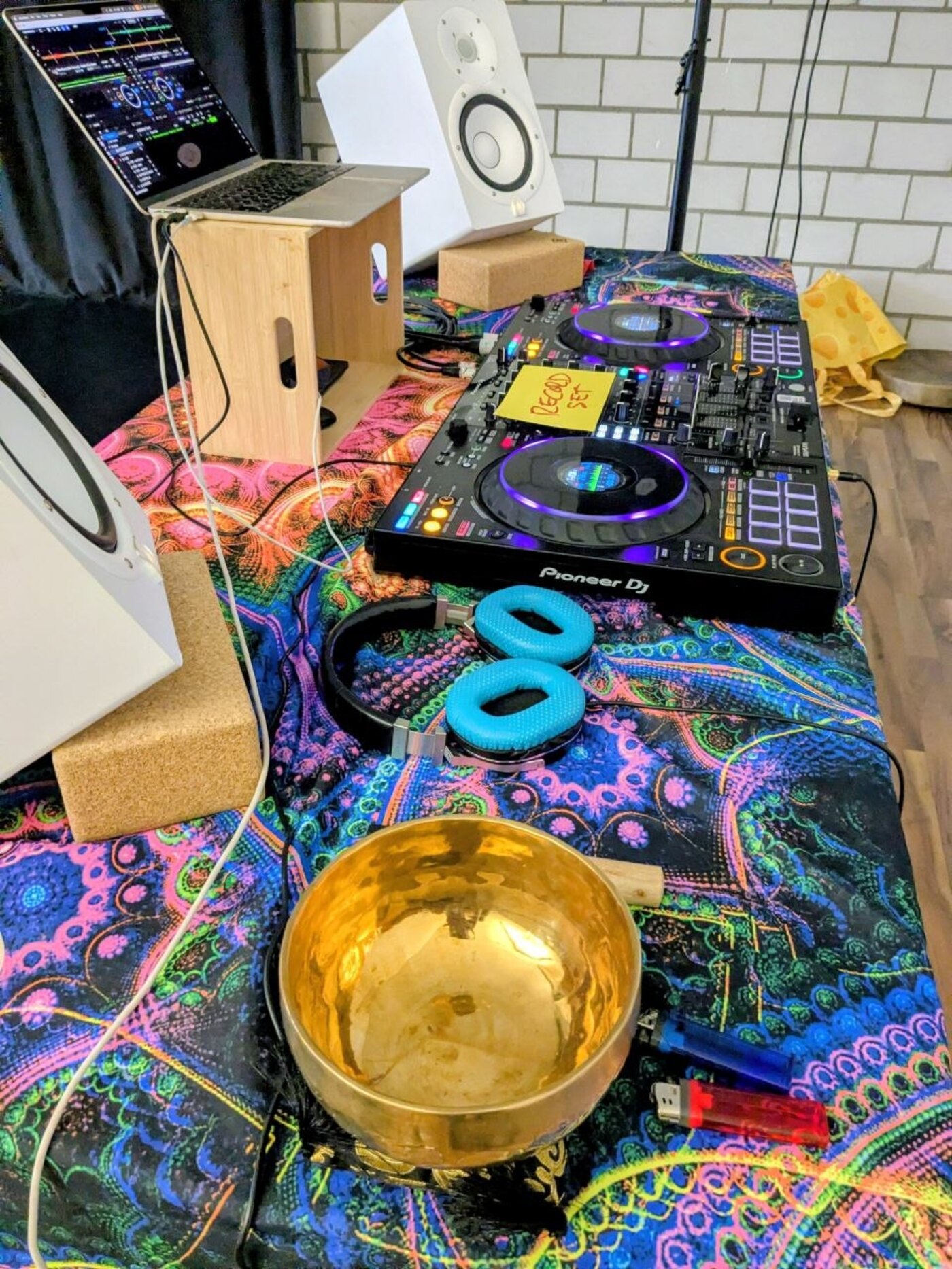 DJ Psysoul's Pioneer setup beside a brass singing bowl and sound-healing instruments